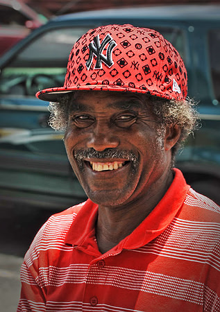 Man living on the streets of St. Thomas. Terrible hat but a nice smile